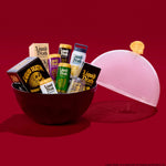 Assorted 'Liquid Death' products in a bowl with a lid on a red background