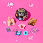 Collection of Britney Spears merchandise including a vinyl record, t-shirt, and accessories on a pink background.