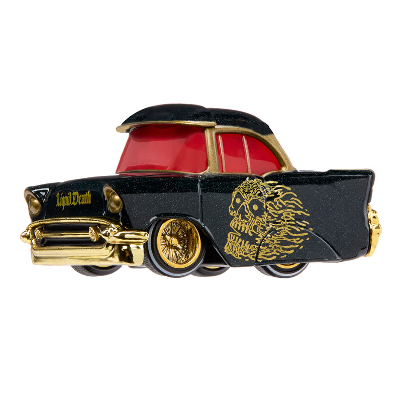A black classic toy car with gold trim, a red windows, and gold skull graphics on the side, shown against a plain white background.