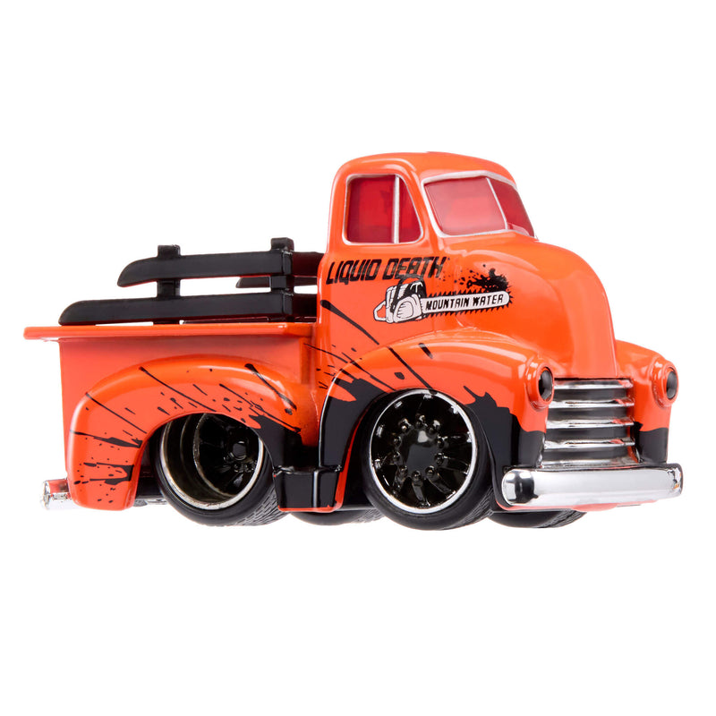 An orange die-cast toy pickup truck with black splatter decals, 'Liquid Death' and 'Mountain Water' branding on the side, and black wheels, shown against a plain white background.