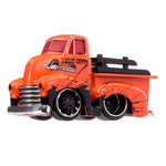 An orange and black die-cast toy truck with 'LIQUID DEATH' branding on the side, featuring a custom hot rod design with black wheels, chrome grille, and black bed rail, shown against a plain white background.