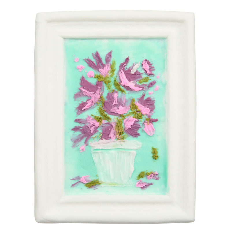 A white picture featuring a painted still life of pink flowers in a white pot against a light aqua background.