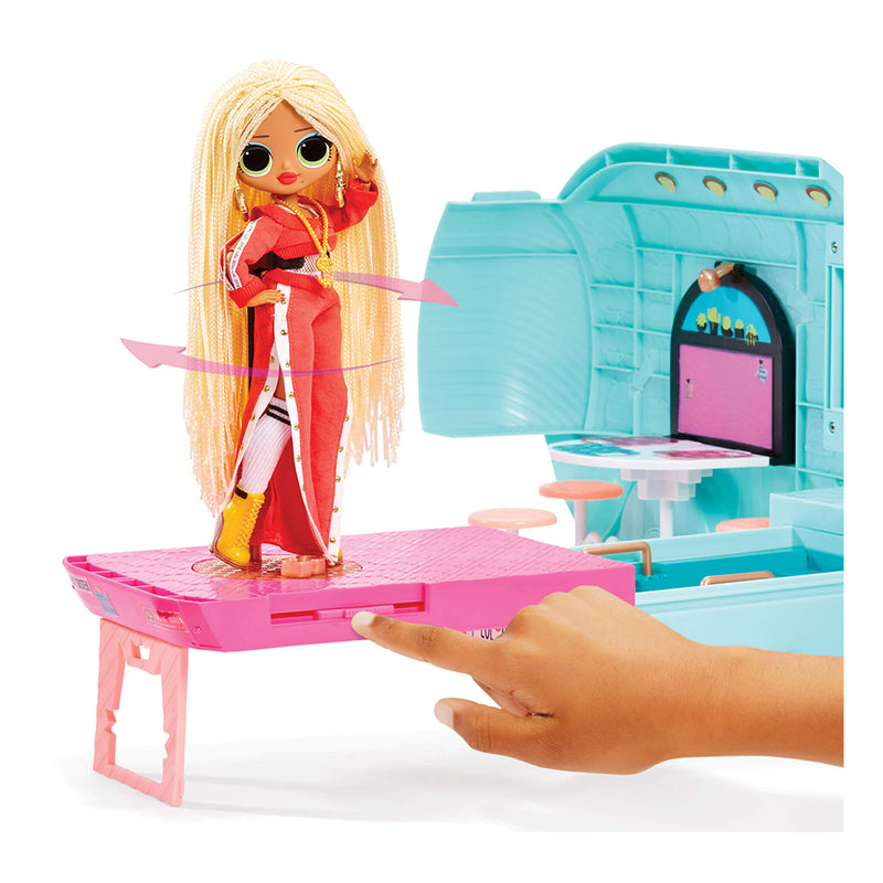 Fashion doll wearing a red jumpsuit with long braided hair on a pink platform dancing.