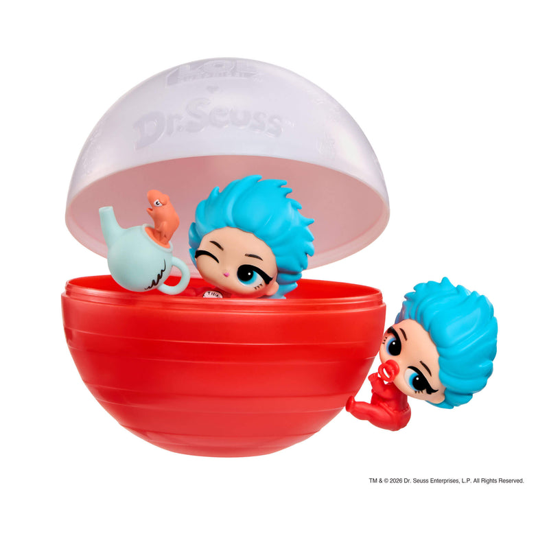 Thing 1sitting inside the red bottom of the ball with a teapot, the white top half is lifted just above. Thing 2 is climbing the red ball.