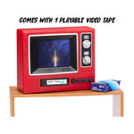 A retro-style red television set displayed on a small wooden table, with a blue video tape box beside it and the text 'COMES WITH 1 PLAYABLE VIDEO TAPE' above. The TV screen shows a rocket launch scene.