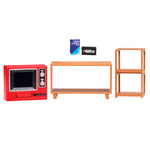 A miniature furniture set featuring a red retro television, a light brown wooden console table, a matching two-tier shelf, and a blue VHS video case, displayed on a clean white background.