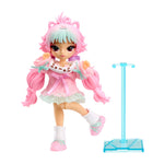 A doll with pink hair, blue bangs, fairy wings, stands on a white background pink sweater dress with mint green ribbon details, ruffled lace, and a super cute cat face. To the right is a blue doll stand.