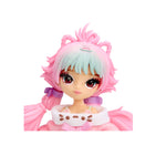 Head shot of doll with brown eyes, blue and pink hair on a white background