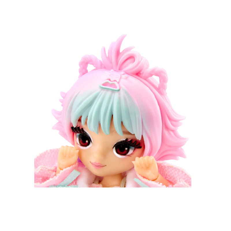 A close-up of the doll’s pink hair with expressive details like cat ears, blue bangs and brown eyes on a white background.