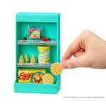 Miniature teal toy shelf with food items and a hand holding a mini waffle cookie.