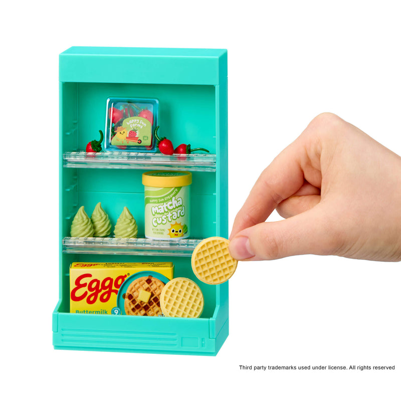 Miniature teal toy shelf with food items and a hand holding a mini waffle cookie.