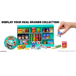 Miniature grocery store display with various food items and a hand holding a mini box.