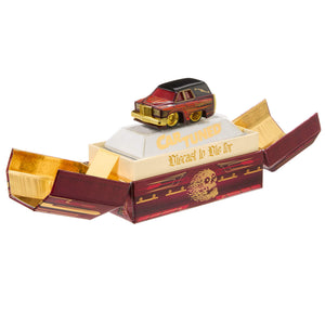 Black and red hearse sitting on a box with both ends open with text in gold 'CarTund' and 'Diecast to Die For'.  