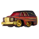 Black and red hearse with red windows, gold wheel rims and “Liquid Death” on the back panel on a white background.