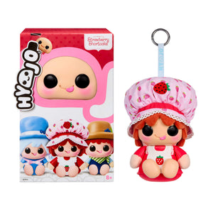 Hyvoo Strawberry Shortcake collectible plush toy shown next to its retail box. The plush features a cute doll design with strawberry-themed clothing, a matching pink strawberry-patterned bonnet, and a silver key ring attached at the top.