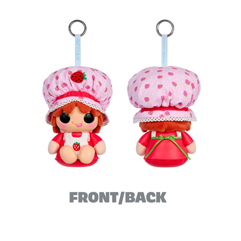 Two views of a strawberry-themed plush doll keychain or bag charm on a white background, labeled FRONT/BACK. The character wears a pink strawberry-patterned bonnet and red outfit, with a light blue hanging strap and metal ring.