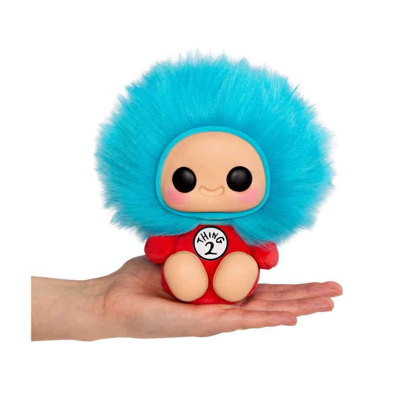 Thing 2 with blue fluffy hair and red outfit sitting in the palm of a hand on a white background