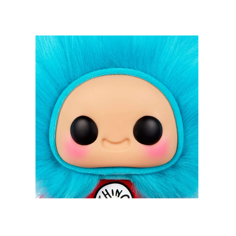Close up of face with big black eyes, rosy cheeks and a smile with blue fluff around the head
