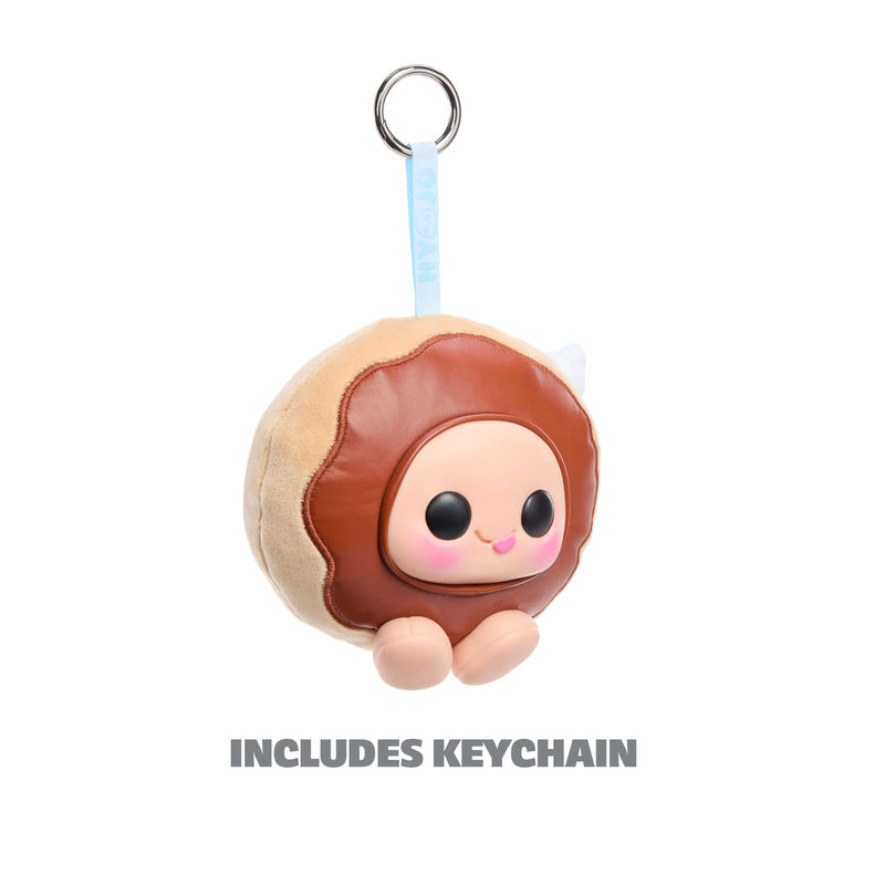 Donut-shaped keychain with a face on a white background