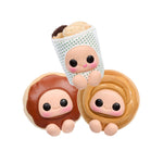 Three cute donut-shaped figurines with faces on a white background