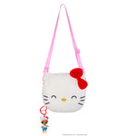Key chain hanging from bottom of bag on a white background