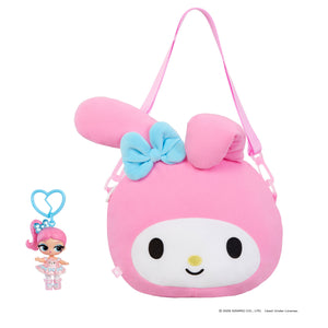 Doll keychain next to a pink bunny bag with blue bow on a white background