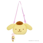 Key chain hanging from bottom of bag on a white background