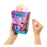 Hands holding a LOL Surprise plush toy packaging with pink ears and unicorn horn on a white background