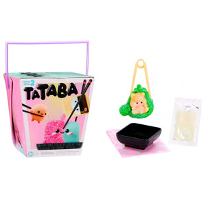 Tataba Series Two toy kit with its pink and teal storage box, a small plush character, a black dish, and a packet of ingredients on a white background.