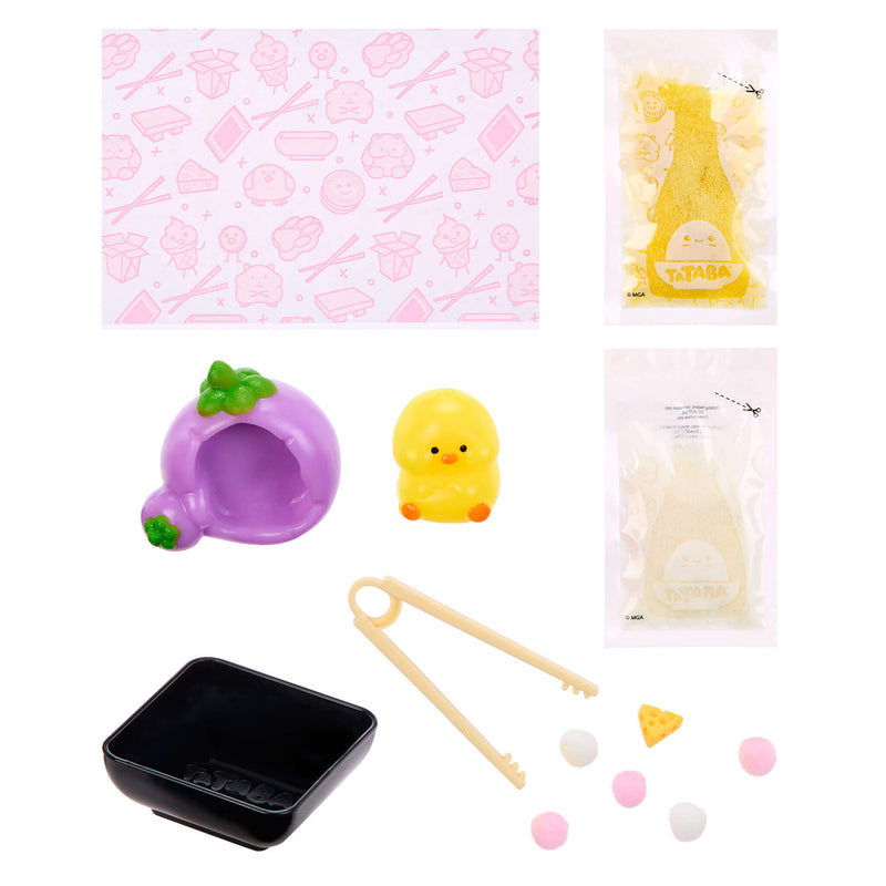A cute food-themed craft playset featuring a pink patterned mat, a purple shaped cave with green leaves, a small yellow chick figure, a black tray, wooden tongs, and several small food-shaped beads and accessories, all arranged on a white background.