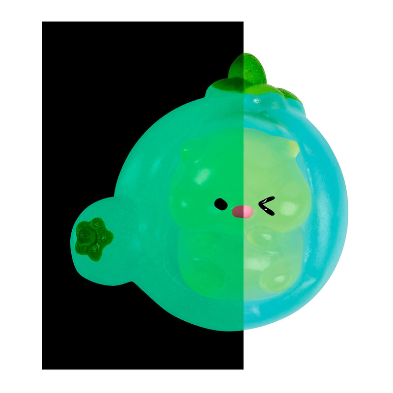 A translucent green and blue squishy toy shaped like a cute bear in a bubble, shown against a split black-and-white background.