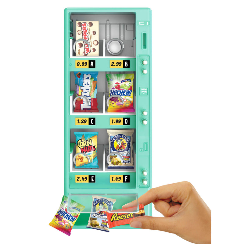 Vending machine toy with colorful candy packages and a hand reaching for a Reese's candy bar.