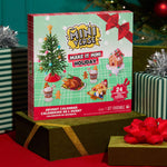 Miniverse Make it Mini Holiday packaging sitting on a gold shiny box with gold ribbon, presents around sitting on a red cloth.