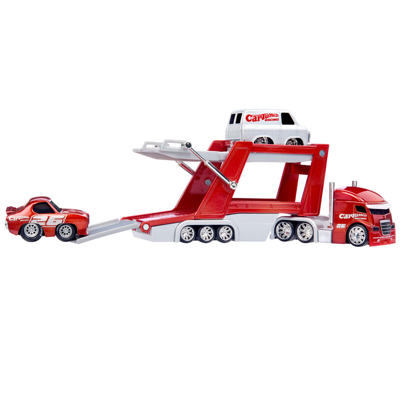 Semi car hauler with grey van sitting on the top and red race car on a gray ramp.