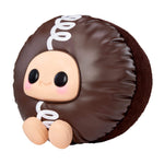 Cupcake sitting to the left with big black eyes and a smile on a white background