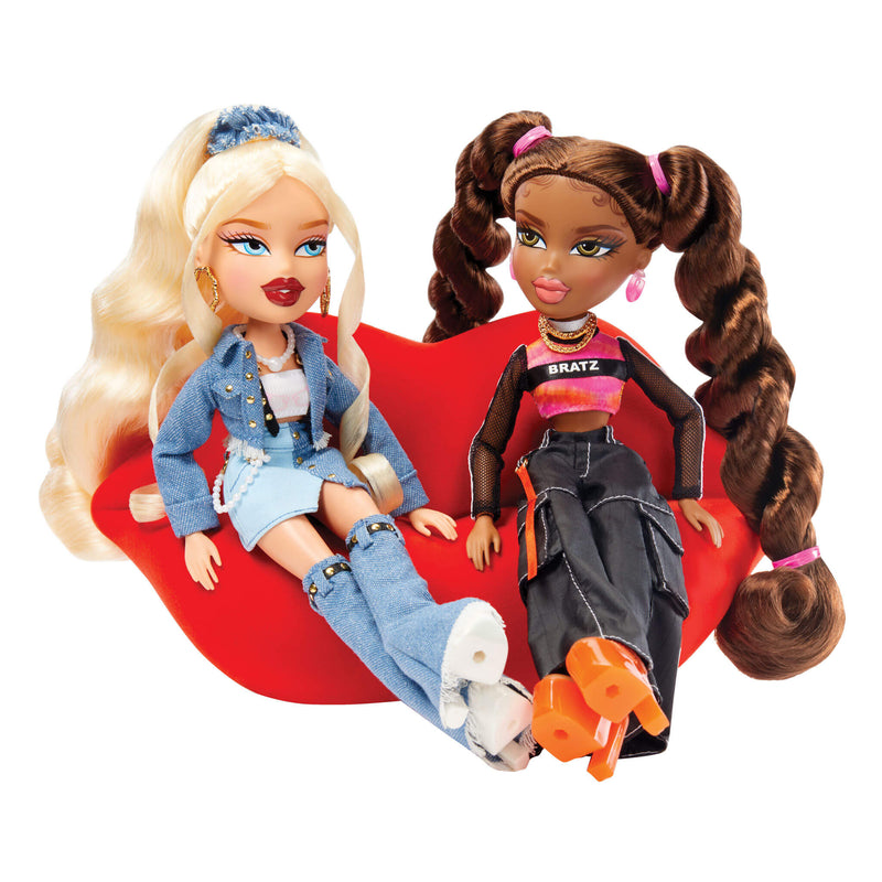 two dolls sitting on couch