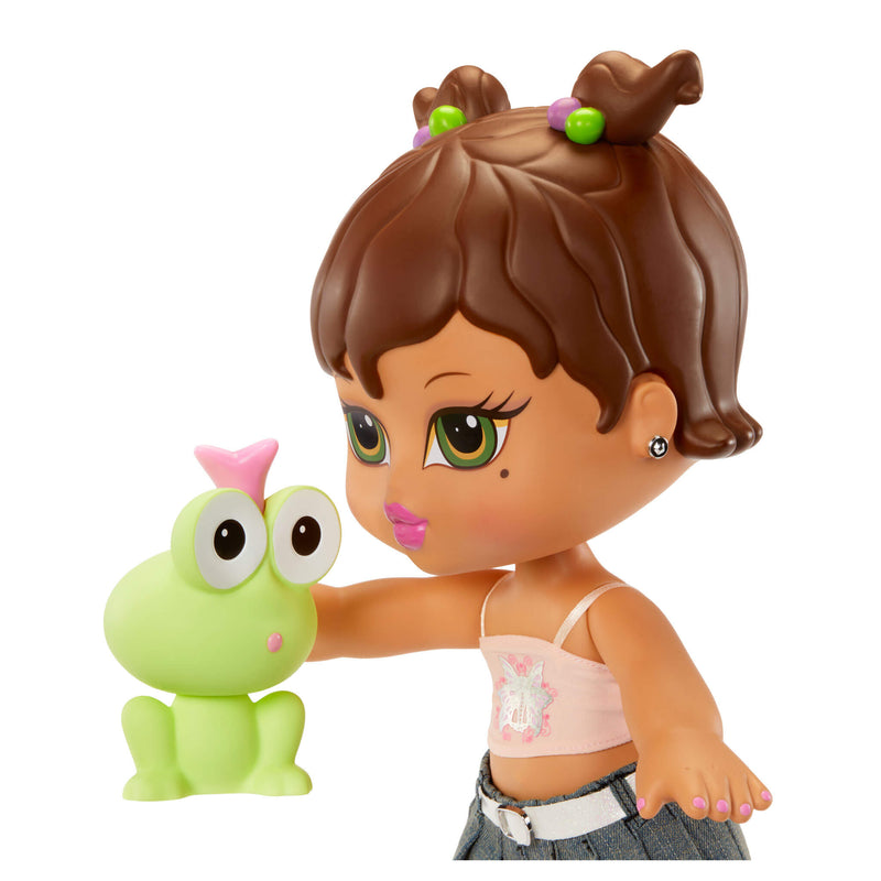 Toy figure of a girl with brown hair holding a green frog toy