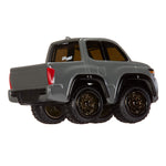 Model truck with large wheels on a white background