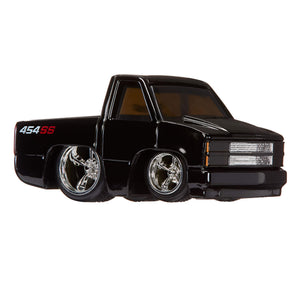 Black toy truck with chrome wheels on a white background