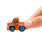 Small orange toy truck with blue wheels held by a hand on a white background
