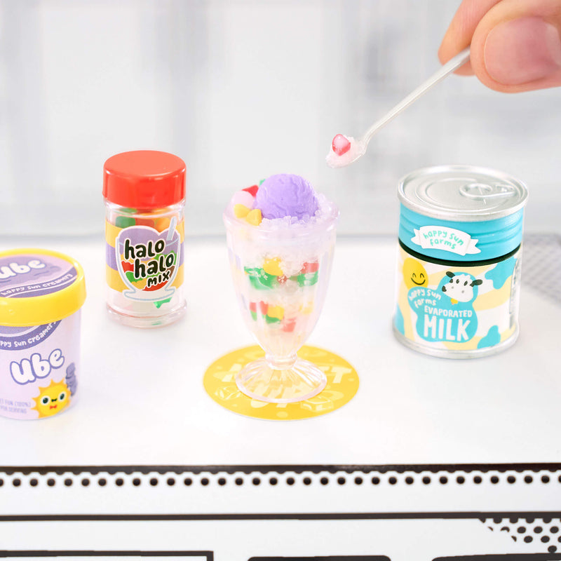 Miniature dessert set with 'halo halo mix' and 'ube' containers on a white surface.