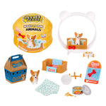 A mini pet set and accessories on a white background, including a round yellow packaging labeled 'Make It Mini Animals,' a brown pet bed with a small dog figure inside, a blue-and-brown box, a dog toy package, bowls, food can, a towel, and other small accessories.