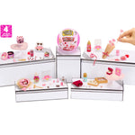 Miniature items with a hand interacting with it on a white background