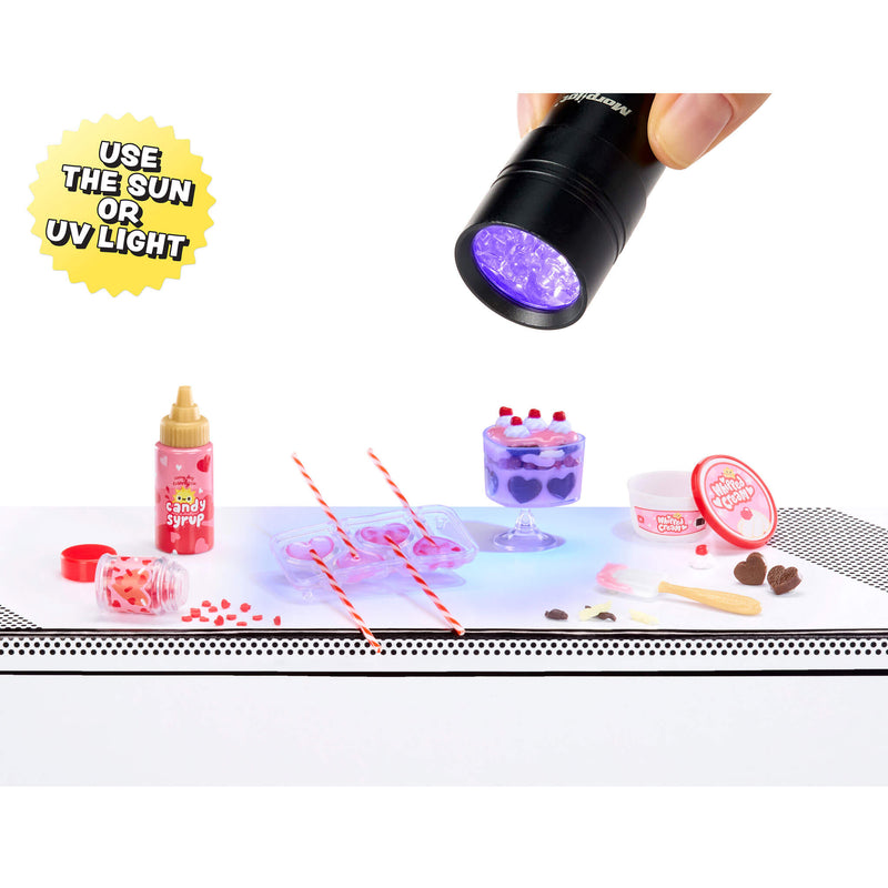 UV light being used on a small table with various items including a bottle, a mold and a container.
