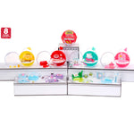 Display of eight colorful toys in clear plastic cases on a white background