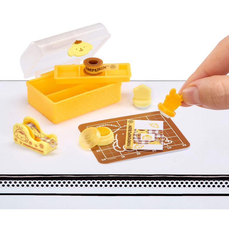 Yellow mini stamp set with a hand holding a shaped stamp on a white background