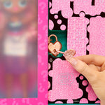 Heart-shaped lock on a pink packaging with a hand interacting with it