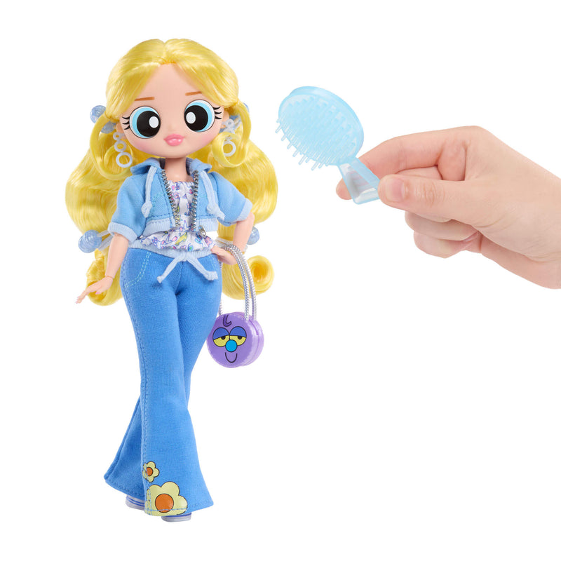 Toy doll with blonde hair and blue outfit holding a brush, on a white background