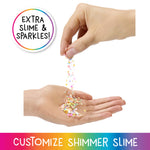 Hand pouring colorful glitter into another hand with text 'Extra Slime & Sparkles' and 'Customize Shimmer Slime'.