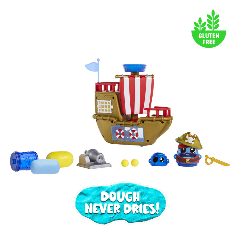 Toy pirate ship set with figures and accessories on a white background, featuring a gluten-free logo and 'Dough Never Dries!' text.